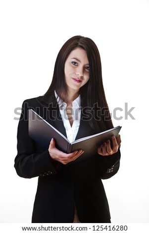 business woman reading from a note book and a light sources is coming from the book