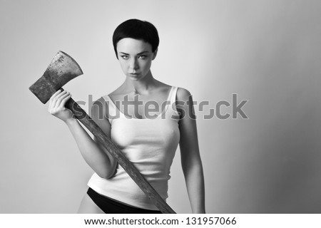 sexy woman wearing a vest top and bikini bottoms looking mean holding a axe
