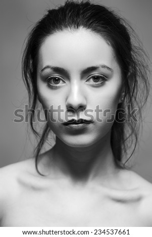 black and white portrait of a young woman with messy hair