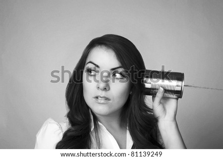 young woman useing a tin can string phone