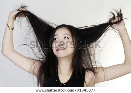 woman looking up pulling at her her having a bad hair day