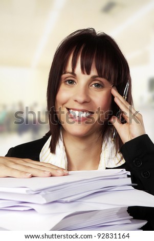 woman at a desk with a lot of paper work to get through