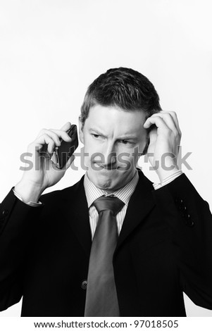 businessman taking a call and he\'s looks like he not sure about something
