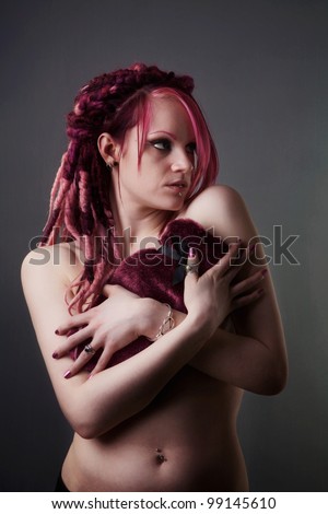 naked woman holding a hot water bottle to keep her warm and to cover up her lady bits