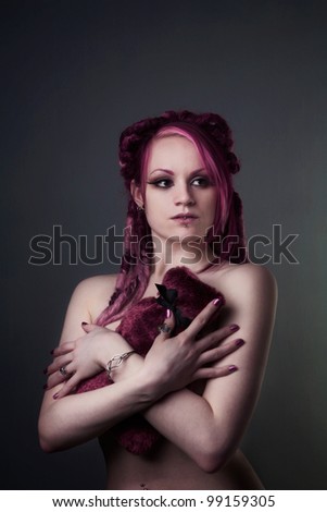 naked woman holding a hot water bottle to keep her warm and to cover up her lady bits