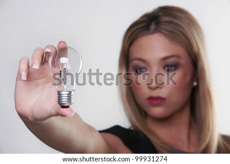beautiful woman holding up a light bulbs