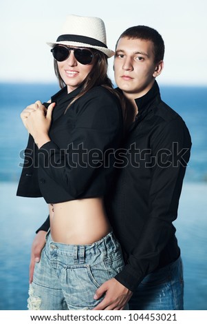 Young couple. Sea on the background