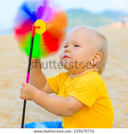 Baby playing with toy windmill