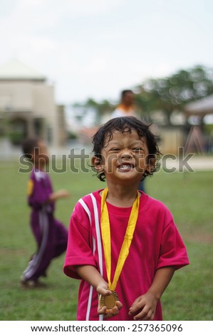 5 years old boy with his winning medal