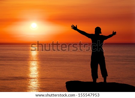Silhouette of man on top of mountain at sunset. Man on peak of mountain. Conceptual design.