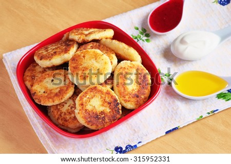 Syrniki. Cottage cheese pancakes. Fritters of cottage cheese, traditional dish Ukrainian and Russian cuisine.