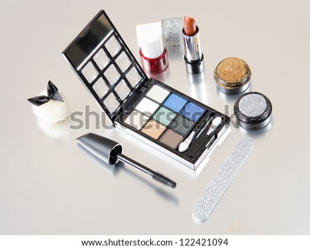 Makeup kit on silver background