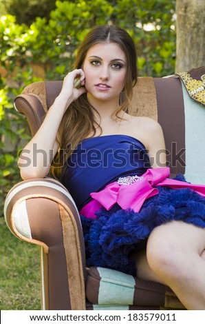 thoughtful girl relaxing at sofa in outdoors garden