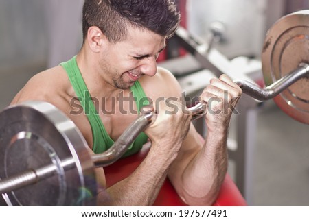 Man doing fitness biceps exercise at old gym in close up frame
