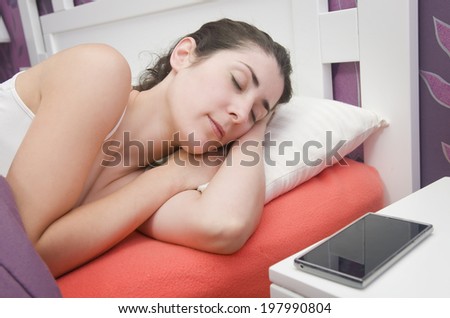 Beauty woman sleeping near to her alarm clock smart phone