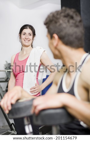 Man and Woman in gym taking conversation