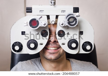Young boy in an optical phoropter scans machine exams his vision and optometry