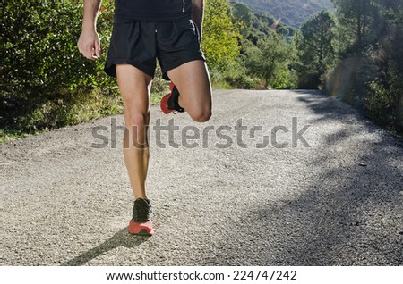 Runner man warming arms and legs with sun light shadow, warm up and stretching