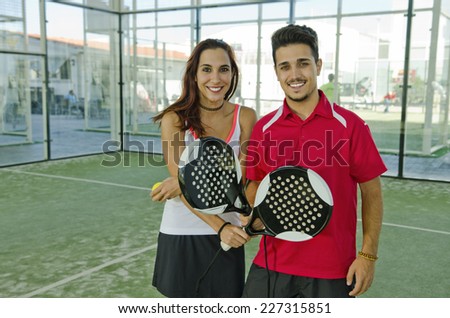 Man and woman are a paddle tennis team in mixed tournament