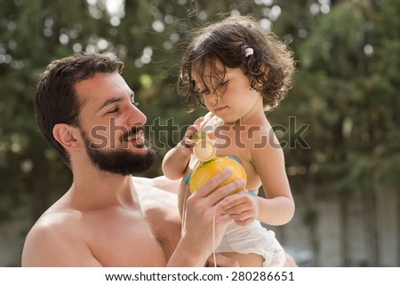 father and baby in summer time at outdoors garden