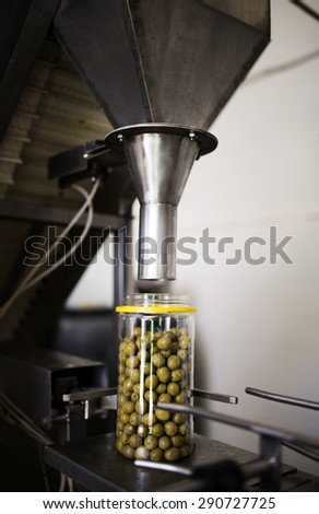 Industrial image of olive oil filler machine with ambient light