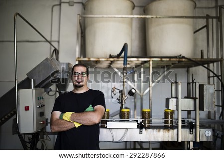 Candid photos of realistic man man working in olives factory