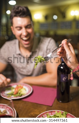 Blurred man ready for eat salad at restaurant