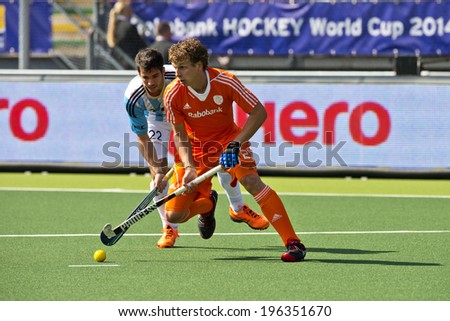 THE HAGUE, NETHERLANDS - JUNE 1: Field hockey player Jonker (NED) leads the ball in front of Rey (ARG)  during the Hockey World Cup 2014 during the match between Netherlands and Argentina (3-1)