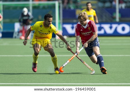 THE HAGUE, NETHERLANDS - JUNE 2: English field hockey player Ashley Jackson crosses sticks with an unidentified Indian player at the Rabobank World Cup Hockey. ENG beats IND 2-1