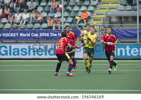 THE HAGUE, NETHERLANDS - JUNE 2: Australian Hayward lifts his stick to control a high ball, surrounded by Spanish players during the Hockey World Cup 2014. AUS beats SPA 3-0