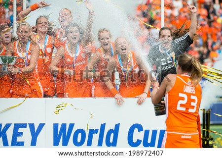 THE HAGUE, NETHERLANDS - JUNE 14: Captain Maartje Lammers of the Dutch field hockey team sprays champagne over her team mates after winning the world championships, beating Australia 2-0