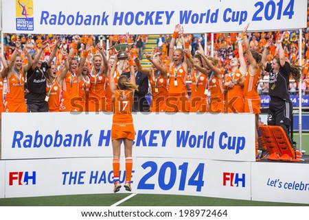 THE HAGUE, NETHERLANDS - JUNE 14, Maartje Paumen of the Dutch women field hockey squad presents the trophy to her team after winning the world championships by beating Australia 2-0 in 2014
