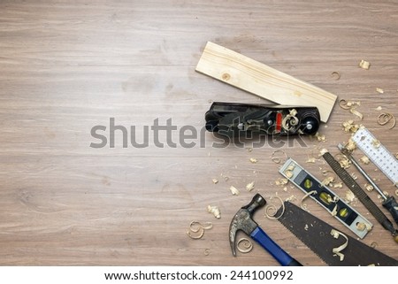 Directly above shot hand jack plane with tools and wood shavings on floor