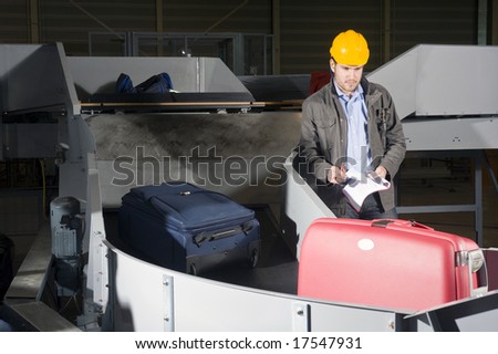 A security staff manually checking luggage after the airport security check at the luggage conveyor belts