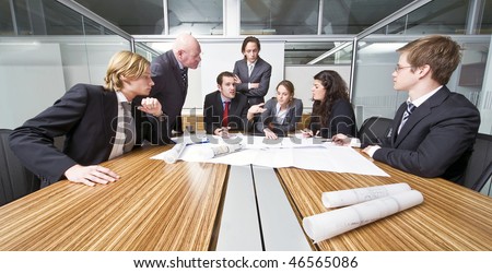 A group of six junior associates during a management team meeting with a senior manager