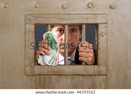 White collar criminal in jail for fraud, holding the bars with a substantial amount of cash in his hands