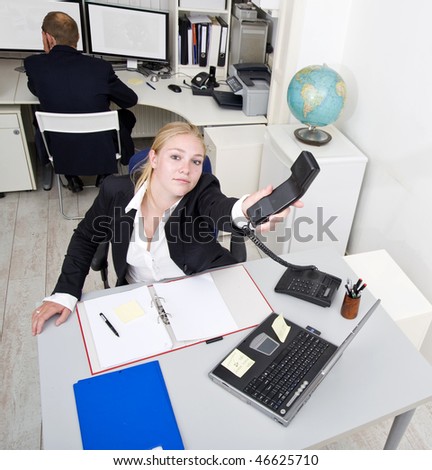 Businesswoman relaying a telephone call to someone else