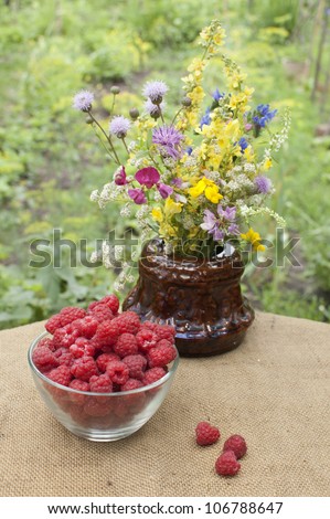 wild flowers and raspberries at table