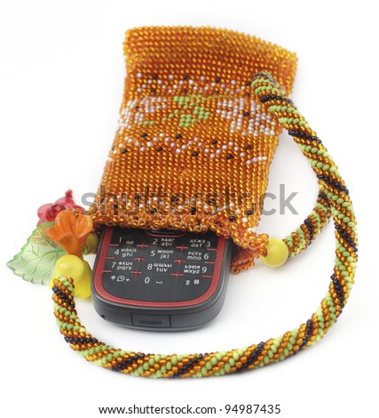 mobile phone in handmade beads purse; white background