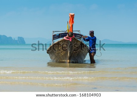 KRABI, THAILAND - DECEMBER 8 : Unidentified boat driver and long-tail boat driver on the shuttle service tourists to the islands on December 8,2013 in Krabi ,Thailand.