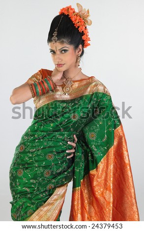 Woman standing in rich green silk-sari in a posing expression