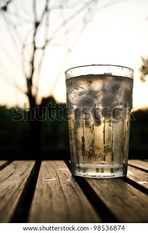 a glass of water in sunset background