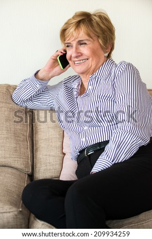Happy Mature woman speaking on the phone