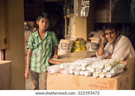 UDAIPUR, RAJASTAN - INDIA: MAY 27 2013 - Unidentified father with his son outside their store on May 27, 2013 in Udaipur, India.