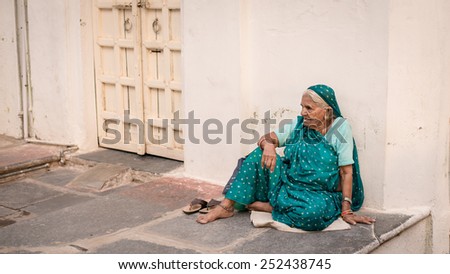 UDAIPUR, RAJASTAN / INDIA - MAY 28 2013 - Unidentified woman sitting outside her home.