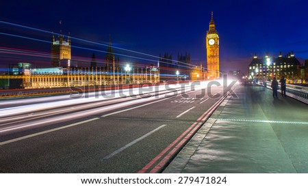 Big Ben clock tower, night shot with cars crossing the bridge.