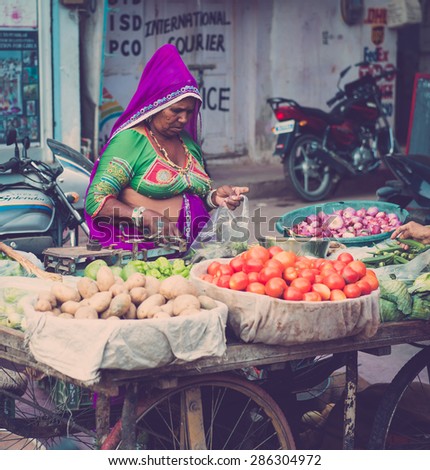 UDAIPUR, RAJASTAN / INDIA - MAY 27 2013 - Unidentified woman selling food at the street market.