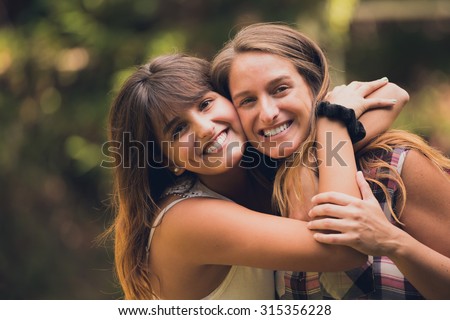 Two sisters hugging each other with love.