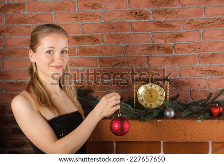 Beautiful woman holding Christmas sphere in hand