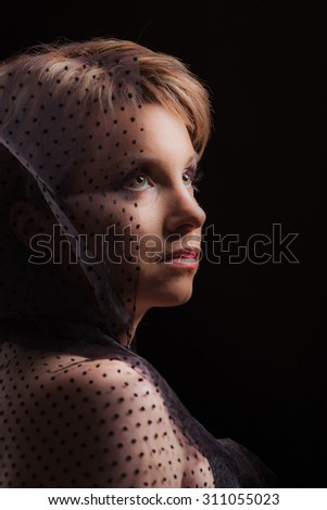 Lovely woman looking forward on dark background
